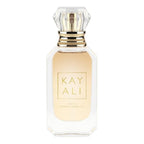 Hub Wavy Kayali Huda Beauty Deja Vu White Flower perfume bottle with white floral and woody accents, 3.4 oz long-lasting fragrance for women.