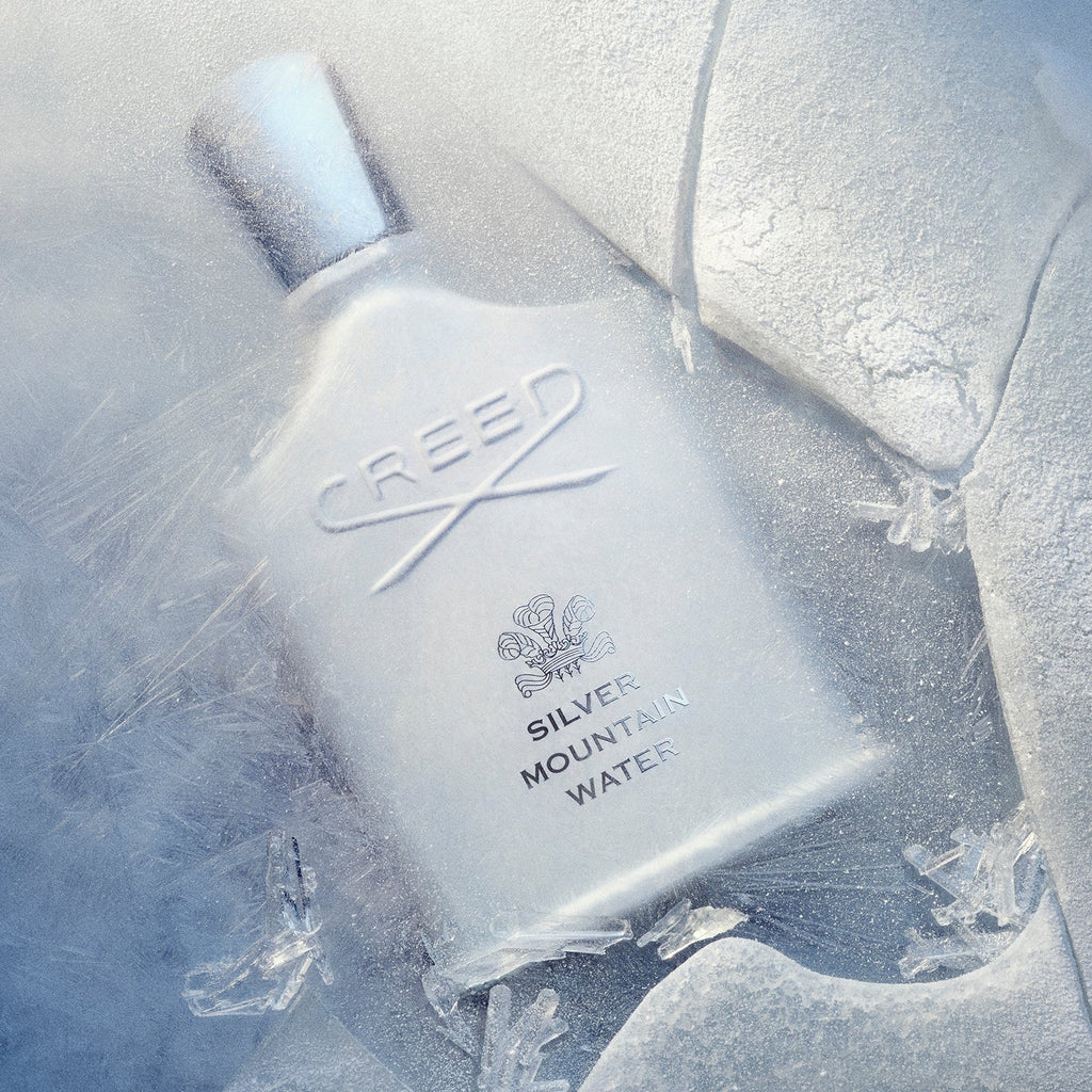 Creed Silver Mountain Water unisex perfume bottle, 3.3 oz / 100 ml, with sleek silver design and clear glass showcasing the fragrance.