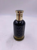 Hugo Boss BOSS Bottled Absolu Intense men's fragrance bottle, 3.3 oz, with sleek design and gold accents, on a neutral background.